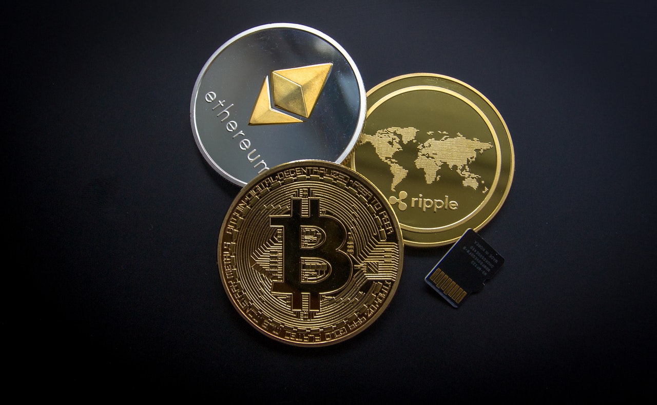 Cryptocurrency 'coins' on a dark background, including Bitcoin and etherum